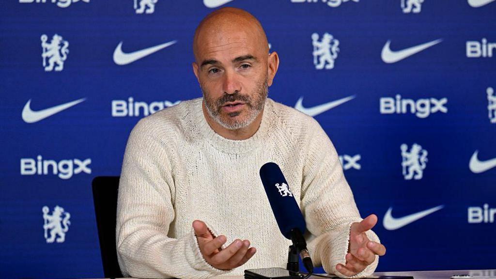 Enzo Maresca talks into a microphone at a news conference