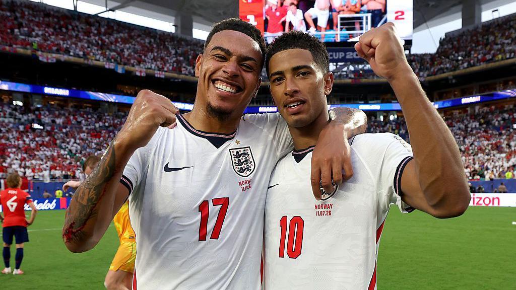 Morgan Rogers and Jude Bellingham of England celebrate with clenched fists after the team's victory over Norway