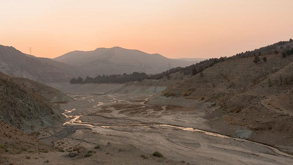 The receding waters of Latyan Dam reveal a dry riverbed near Tehran, Iran, on November 10, 2025. The reservoir, which supplies part of the capital's drinking water, has seen a sharp decline due to prolonged drought and rising demand in the Tehran region
