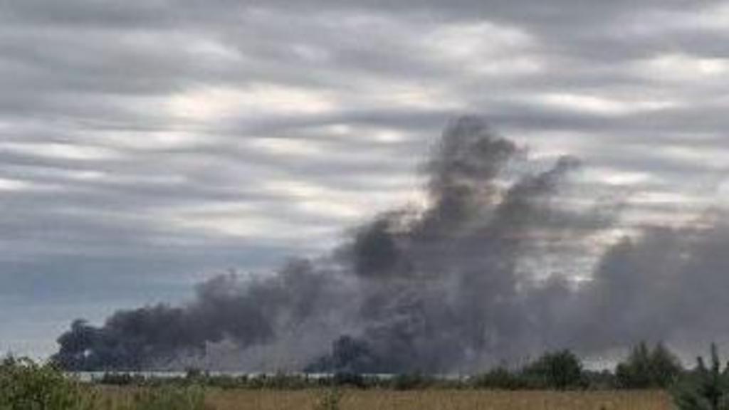 Smole billowing from warehouse, taken from distance