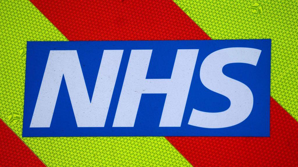 A blue and white logo reading NHS. It is set against a yellow and red background.