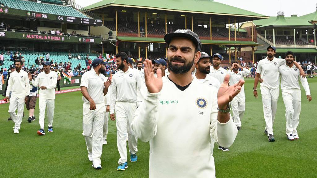 India's captain Virat Kohli (C) applauds as the India team celebrates their series win on the fifth day of the fourth and final cricket Test against Australia at the Sydney Cricket Ground in Sydney on January 7, 2019.