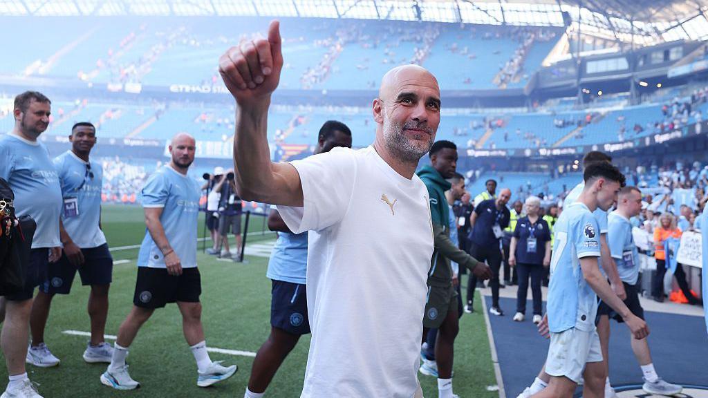 Pep Guardiola putting his thumb up to towards the crowd after his final game as Manchester City manager