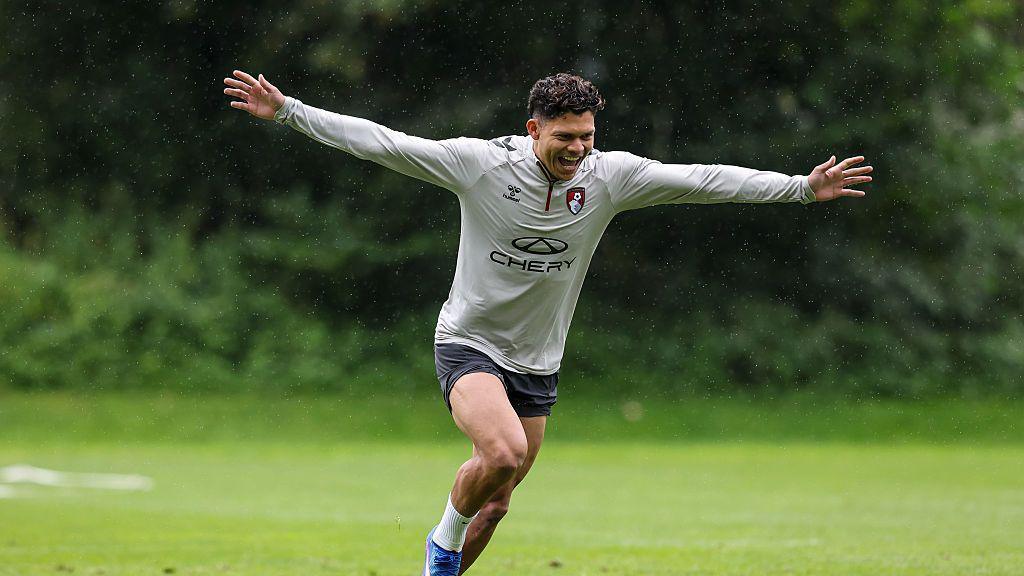 Evanilson smiling and celebrating a goal in Bournemouth training with his arms outstretched