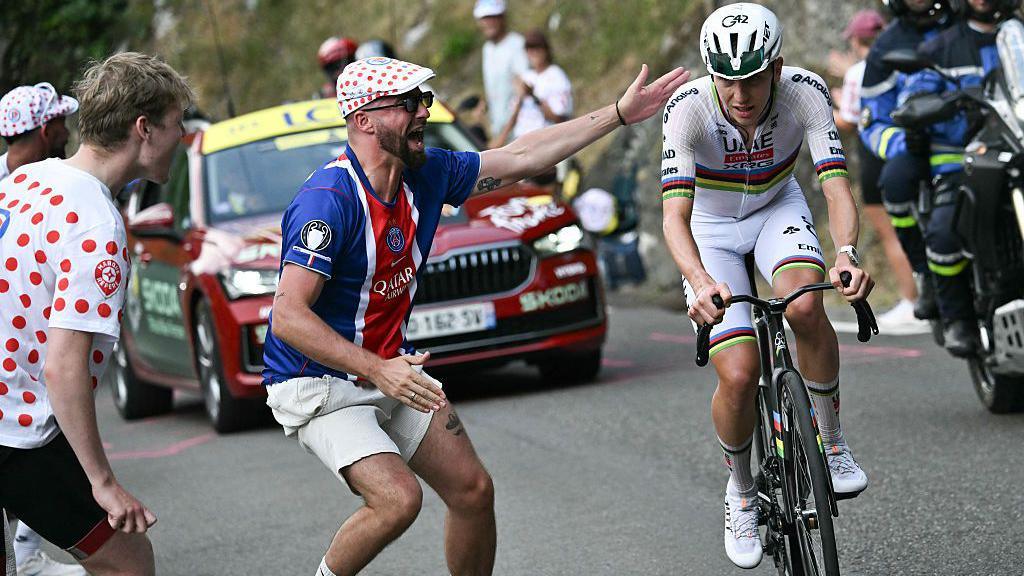 Tadej Pogacar with a fan on the Col du Tourmalet