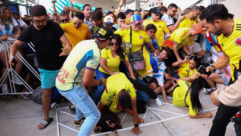 A group of Colombia and Argentina fans fall over during overcrowding before the 2024 Copa America final