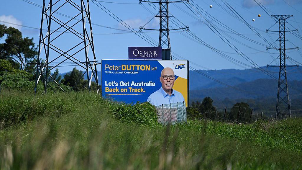 An election advertising board for the LNP and Peter Dutton is seen next to power lines on April 23, 2025 in Strathpine, Brisbane.