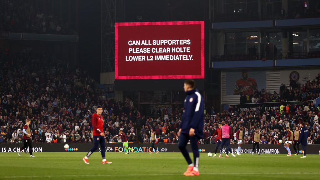 A screen asking supports to clear a stand of the Holte End