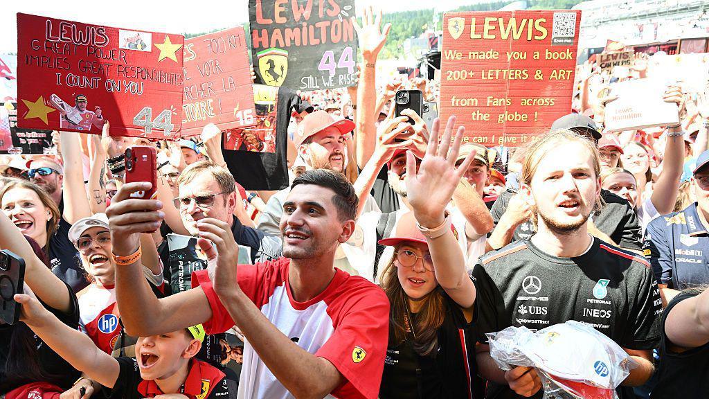 Fans hold up signs for Lewis Hamilton