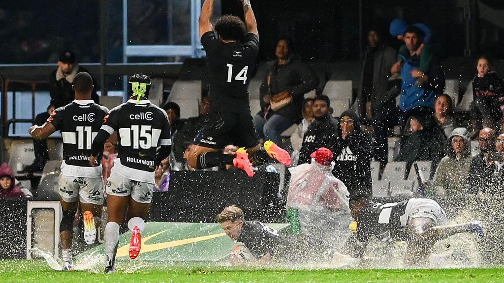 Fehi Fineanganofo of New Zealand All Blacks leaps over Damian McKenzie of New Zealand All Blacks scoring a try