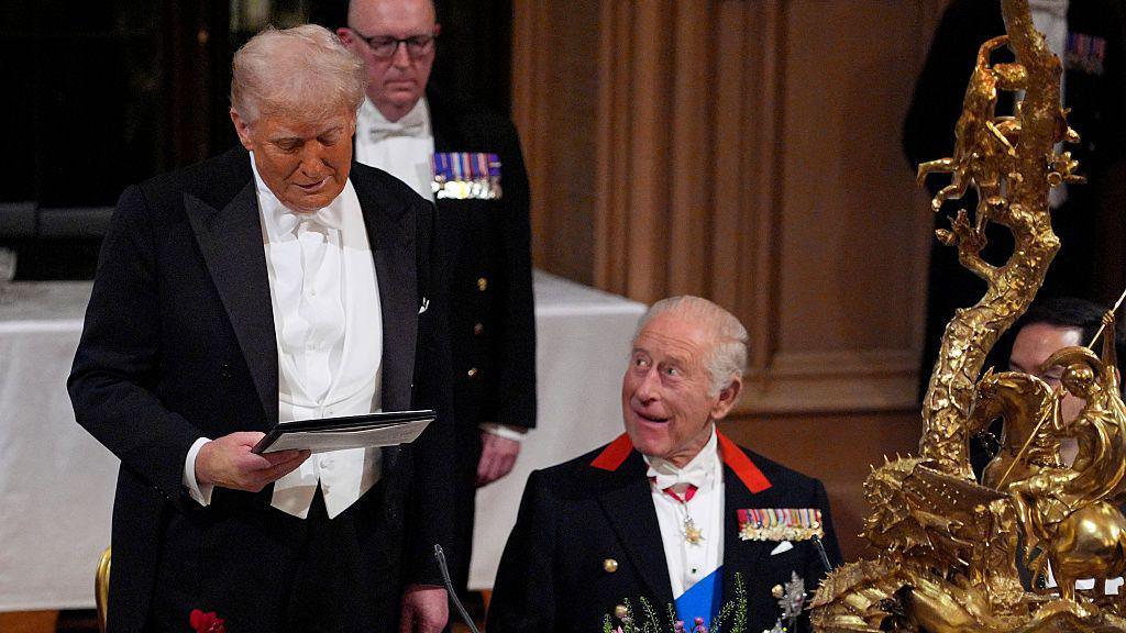 Donald Trump giving a speech next to the King.