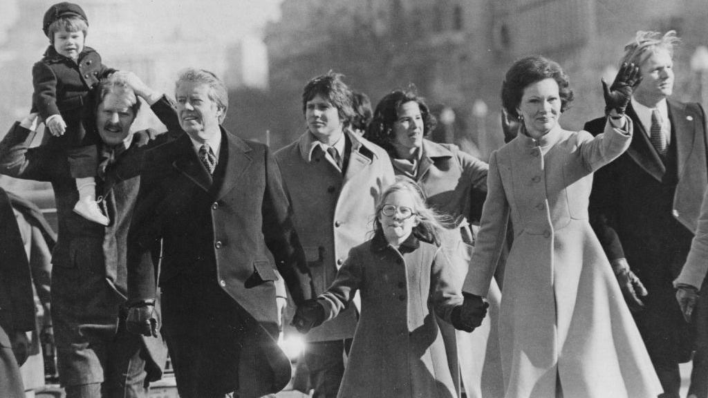 Jimmy, Amy (C) and Rosalynn Carter (R) walk in the presidential inaugural parade in Washington DC in 1977