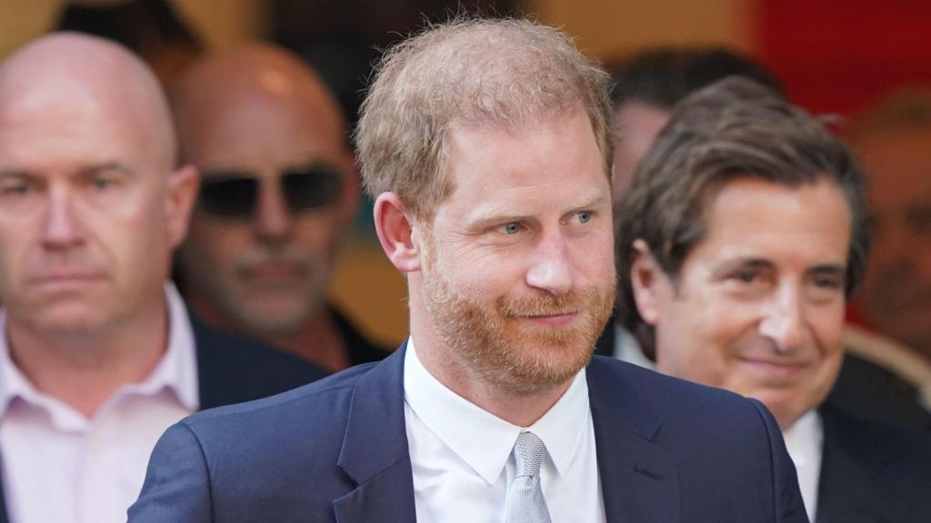 Prince Harry in a dark suit and a grey tie