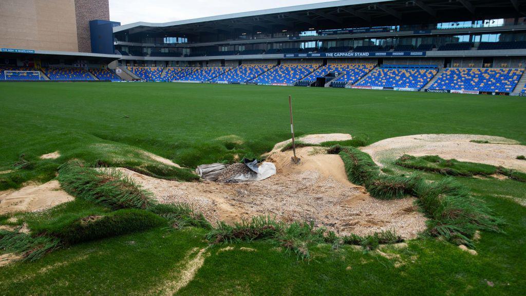 Detailed view of damage to the pitch following flooding at AFC Wimbledon's Cherry Red Records Stadium