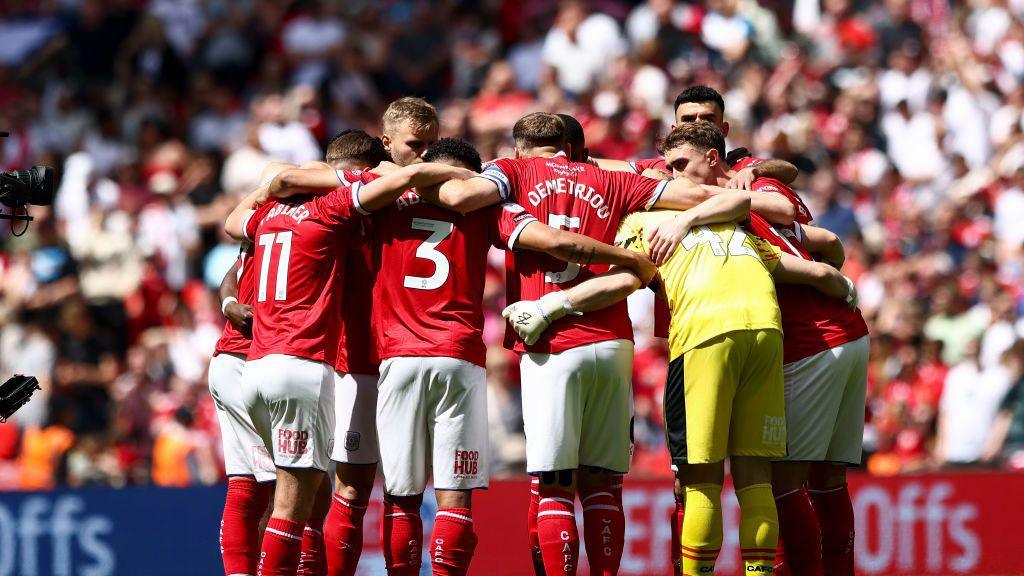 Crewe's players in their Wembley huddle 