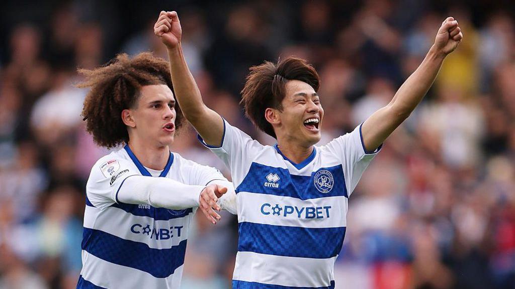 Koki Saito of Queens Park Rangers is pushed to celebrate by team mate Rayan Kolli after the team's victory in the Championship match between Queens Park Rangers and Charlton Athletic 