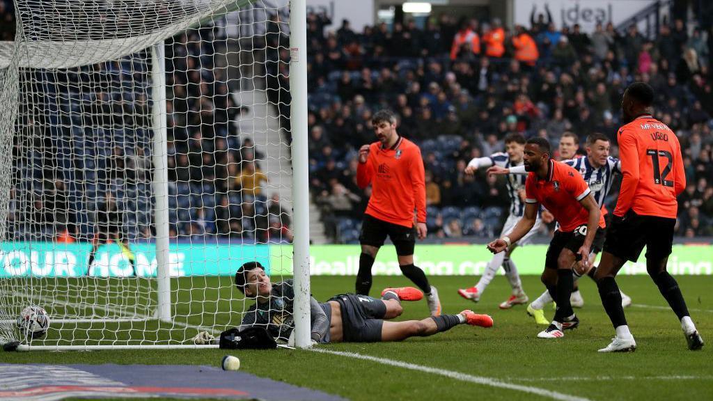 James Beadle lies in the goal as he can't keep out Jayson Molumby's near-post flick 