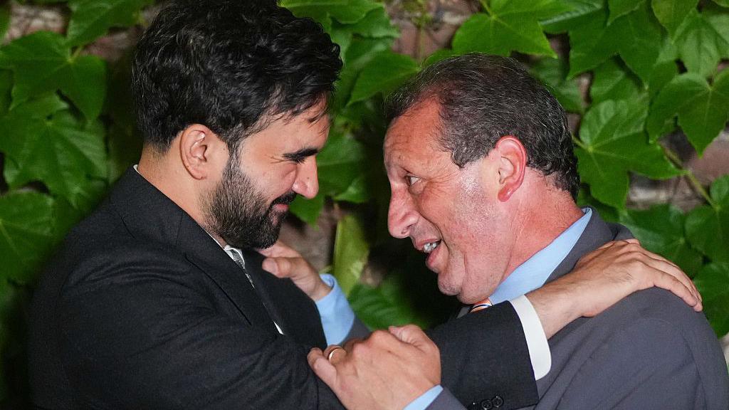 Mamdani and Lander embrace. 