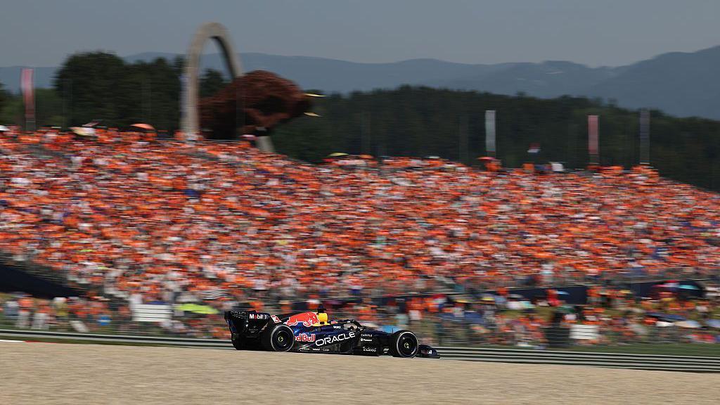 Max Verstappen drives past the Dutch fans in the grandstands at the Red Bull Ring 