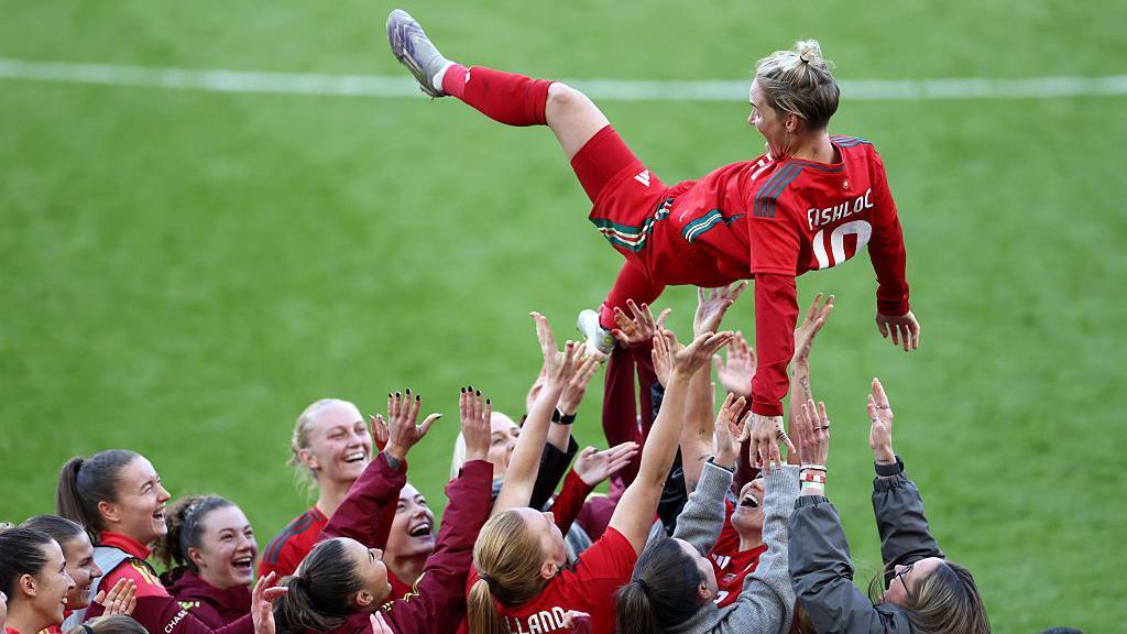 Jess Fishlock is thrown in the air by her team-mates after Wales' friendly with Australia in October 