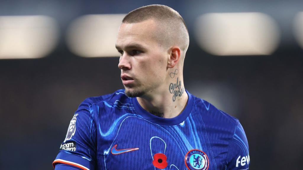 Mykhailo Mudryk looking to his right while playing in a Chelsea kit 