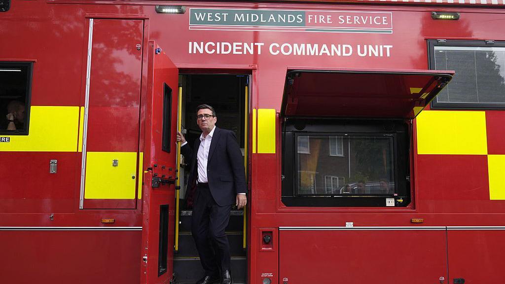 Britain's Prime Minister Andy Burnham leaves the West Midlands Fire Service incident command unit