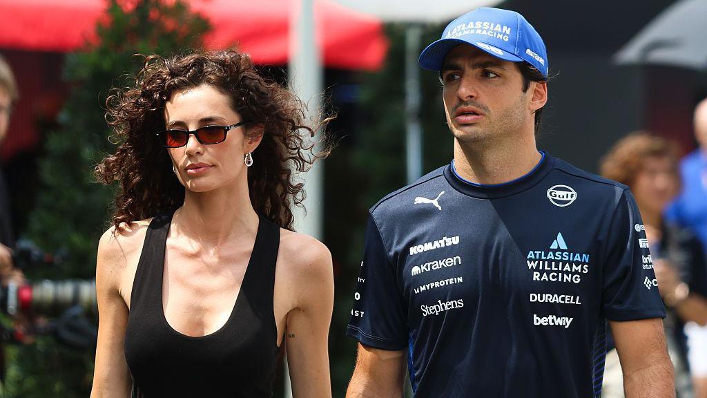 Rebecca Donaldson and Carlos Sainz walk into the paddock in Singapore