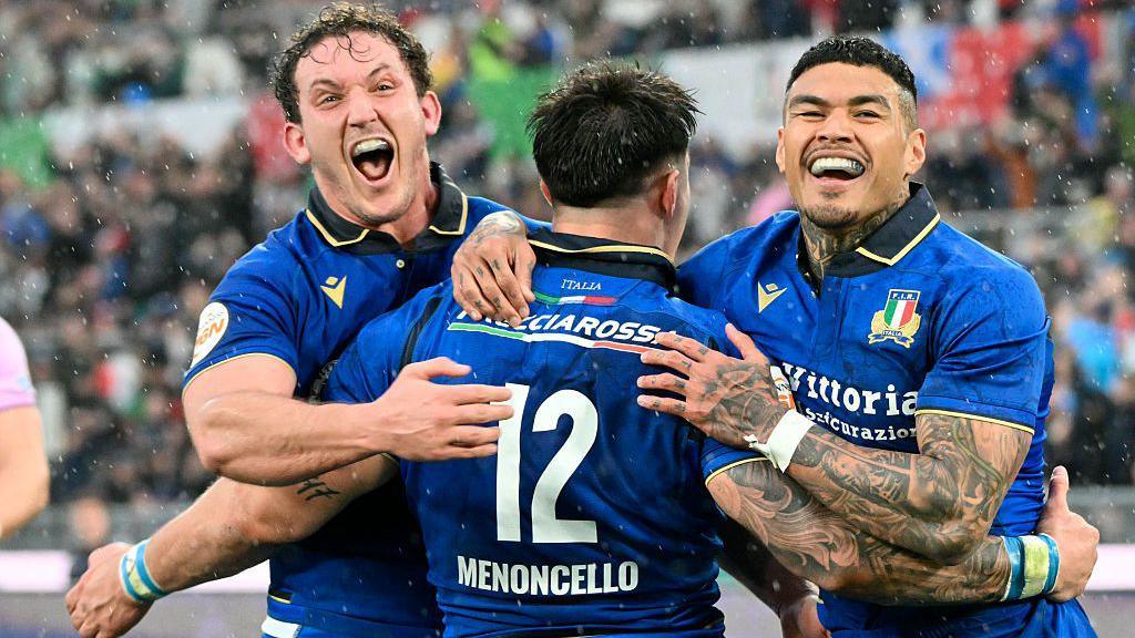 Italy players celebrate beating Scotland