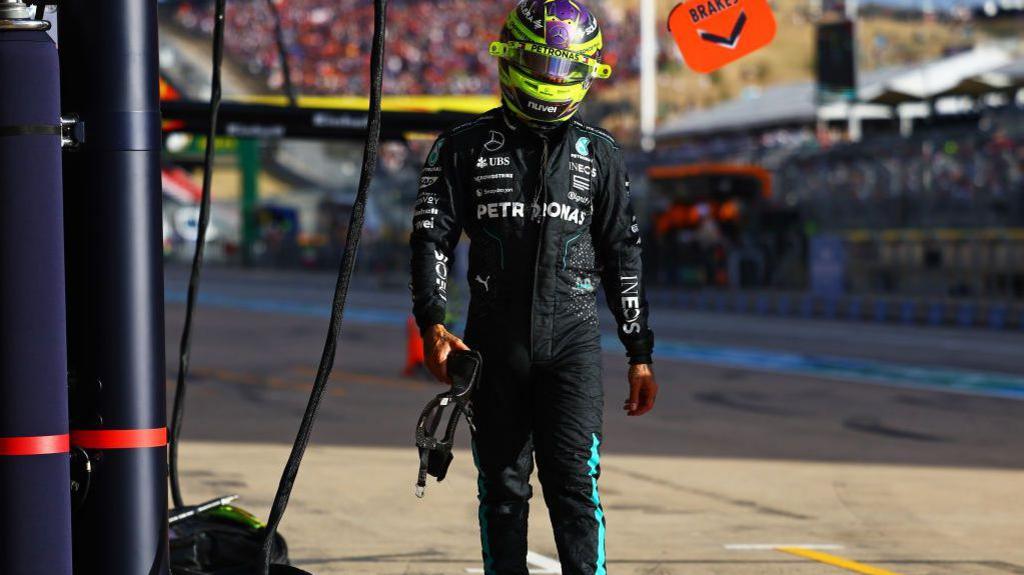 Lewis Hamilton returns to the Mercedes pit garage after failing to progress from Q1