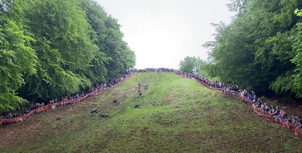 Men rolling down hill