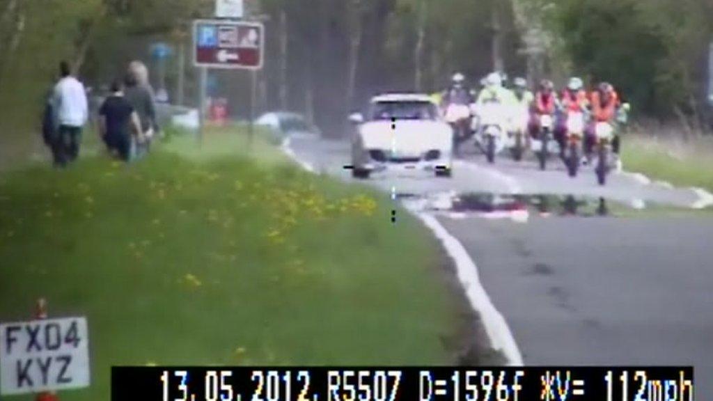 Porsche overtaking a line of motorbikes