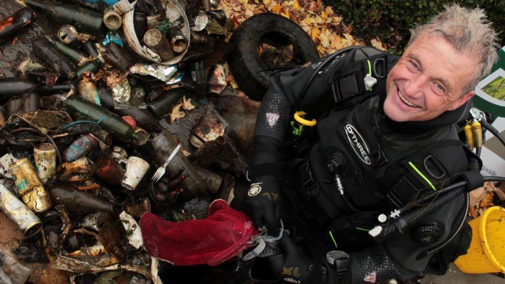 Broadcaster Paul Rose with rubbish found in Windermere