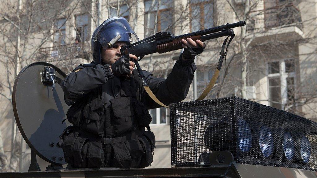 A policeman facing down protestors in Azerbaijan