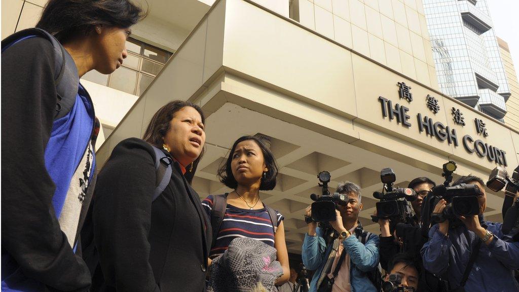 Eni Lestari (R) from Indonesia, Dolores Balladares (C) from the Phillipines and Ganika Diristiani from Indonesia and representing the Asian Migrants' Coordinating Body (AMCB) stand outside of the High Court on the morning that a judgment was to be released by the court of appeal regarding the review of a case in 2011 in which the High Court ruled a Philippine domestic worker had the right to request permanent residency status in Hong Kong on March 28, 2012.