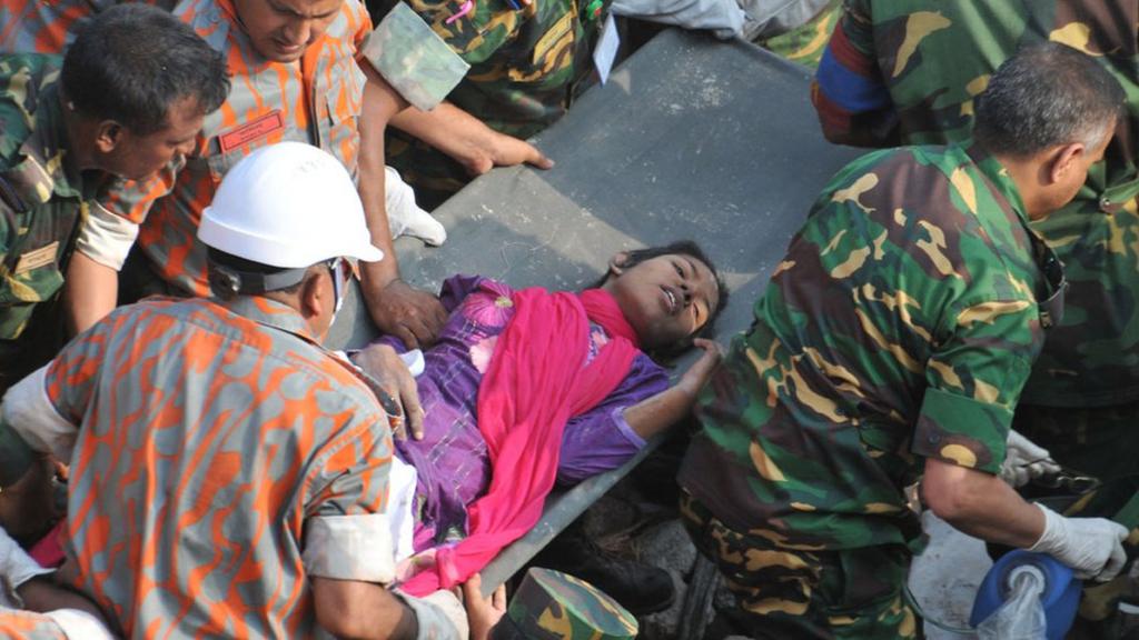 Survivor of Bangladesh building collapse is carried into an ambulance (10 May 2013)