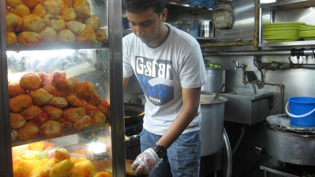 Abdus Salam working at his food stall