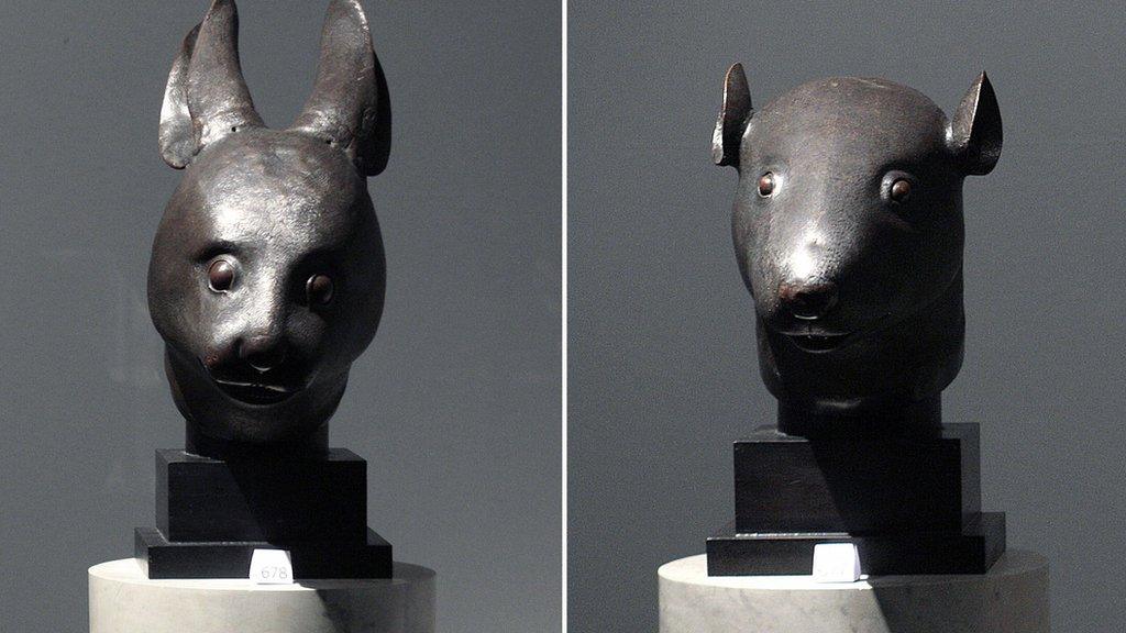 File photo: the bronze rat head statue (left) and rabbit head statue, 21 February 2009