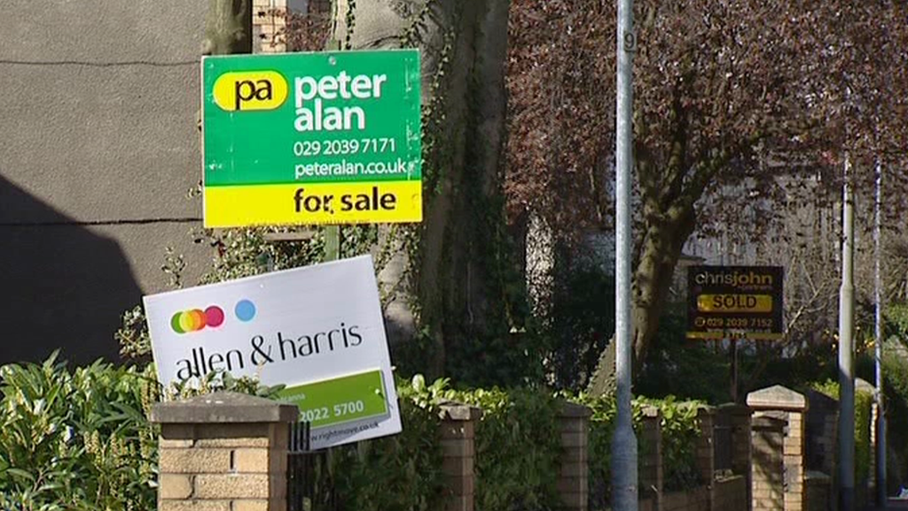 Estate agent boards outside houses in Cardiff