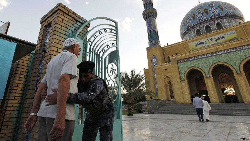 A man is frisked before being allowed to enter a Sunni mosque for prayers.