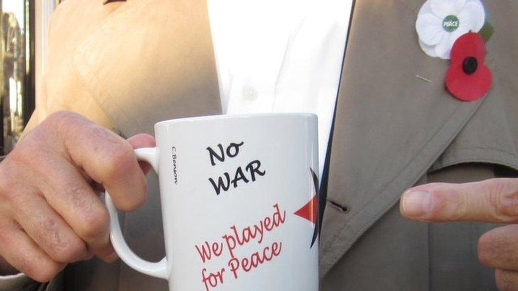 'No war: we played for peace' mug