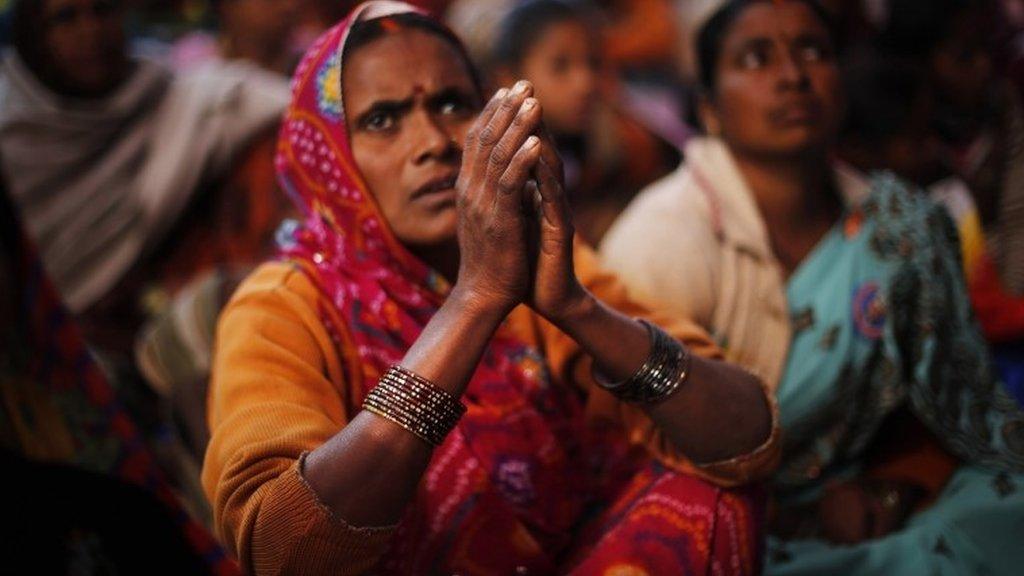 A Dalit woman listens to a speaker with folded hands during a protest on Human Rights Day near the Indian Parliament in Delhi, Tuesday, Dec 10, 2013