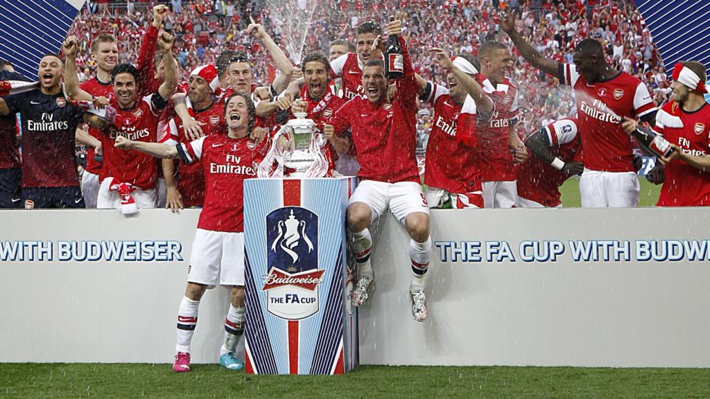 Arsenal celebrate winning the FA Cup on the pitch at Wembley