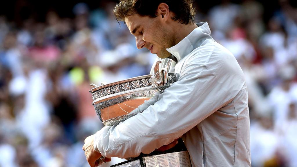 Rafael Nadal reacts as he holds the Musketeers trophy after winning the French tennis Open