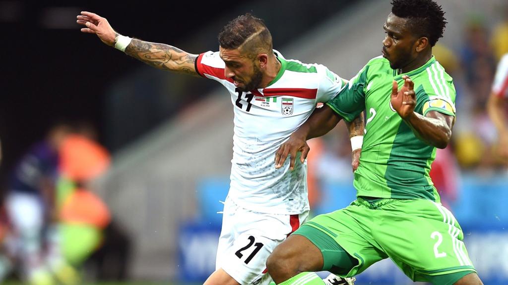 Joseph Yobo of Nigeria challenges Ashkan Dejagah of Iran