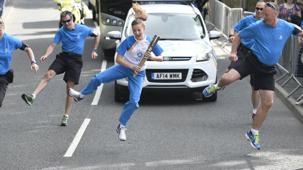 Kirsty Millar carries the Glasgow 2014 Queen's Baton through Duns in the Scottish Borders