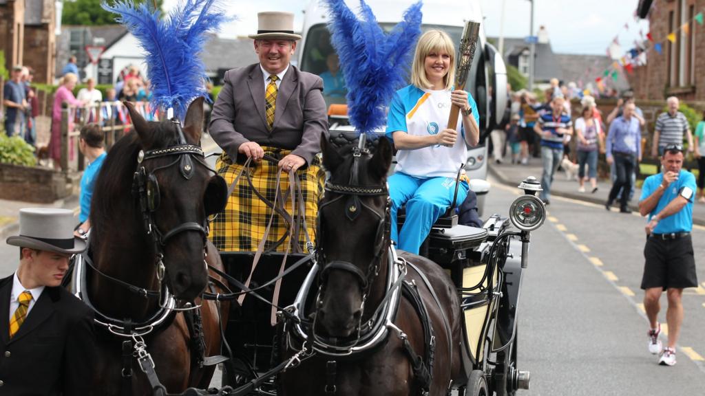 Ashley Jensen carries the Glasgow 2014 Queen's Baton through Langholm in Dumfries & Galloway.