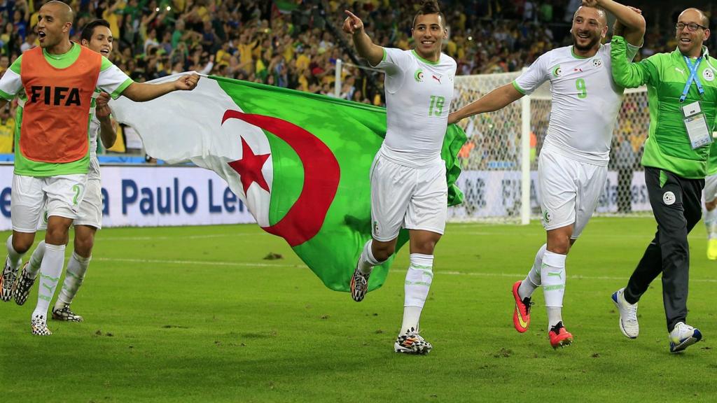 Algeria players celebrate after reaching the last 16 of the 2014 Fifa World Cup