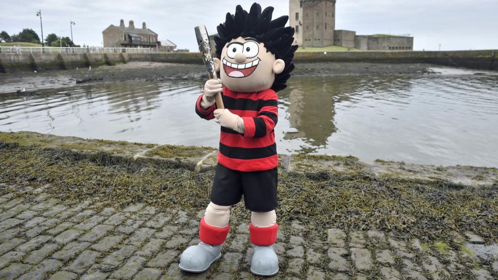 Dennis the Menace holds baton