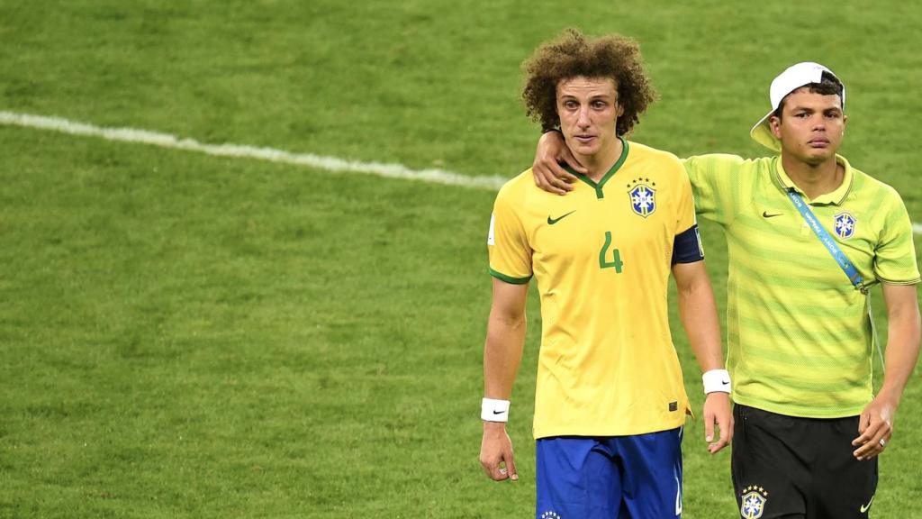 David Luiz is consoled by Brazil's defender and captain Thiago Silva