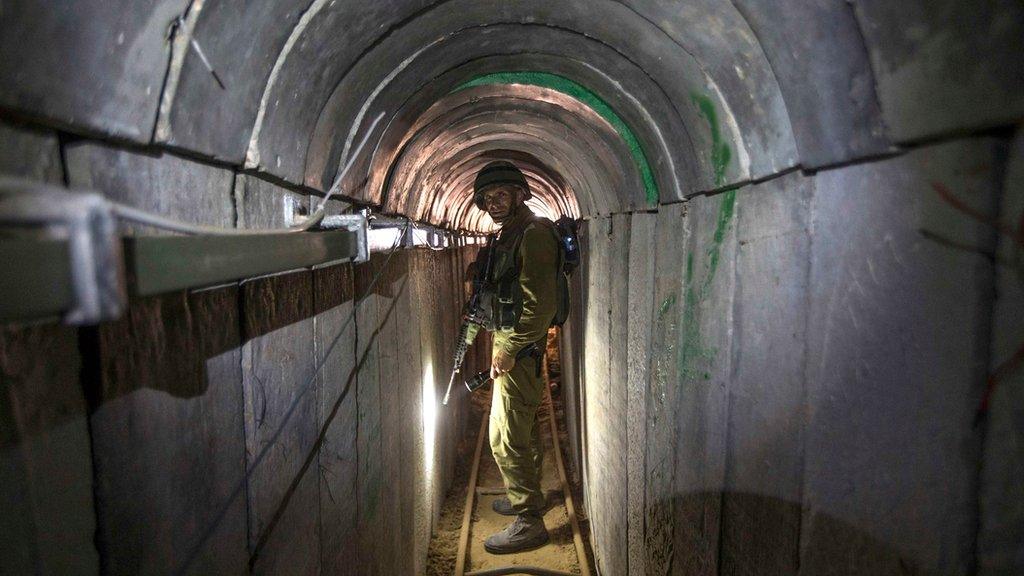 An Israeli soldier stands in a tunnel said to be captured from Hamas militants, 25 July 2014